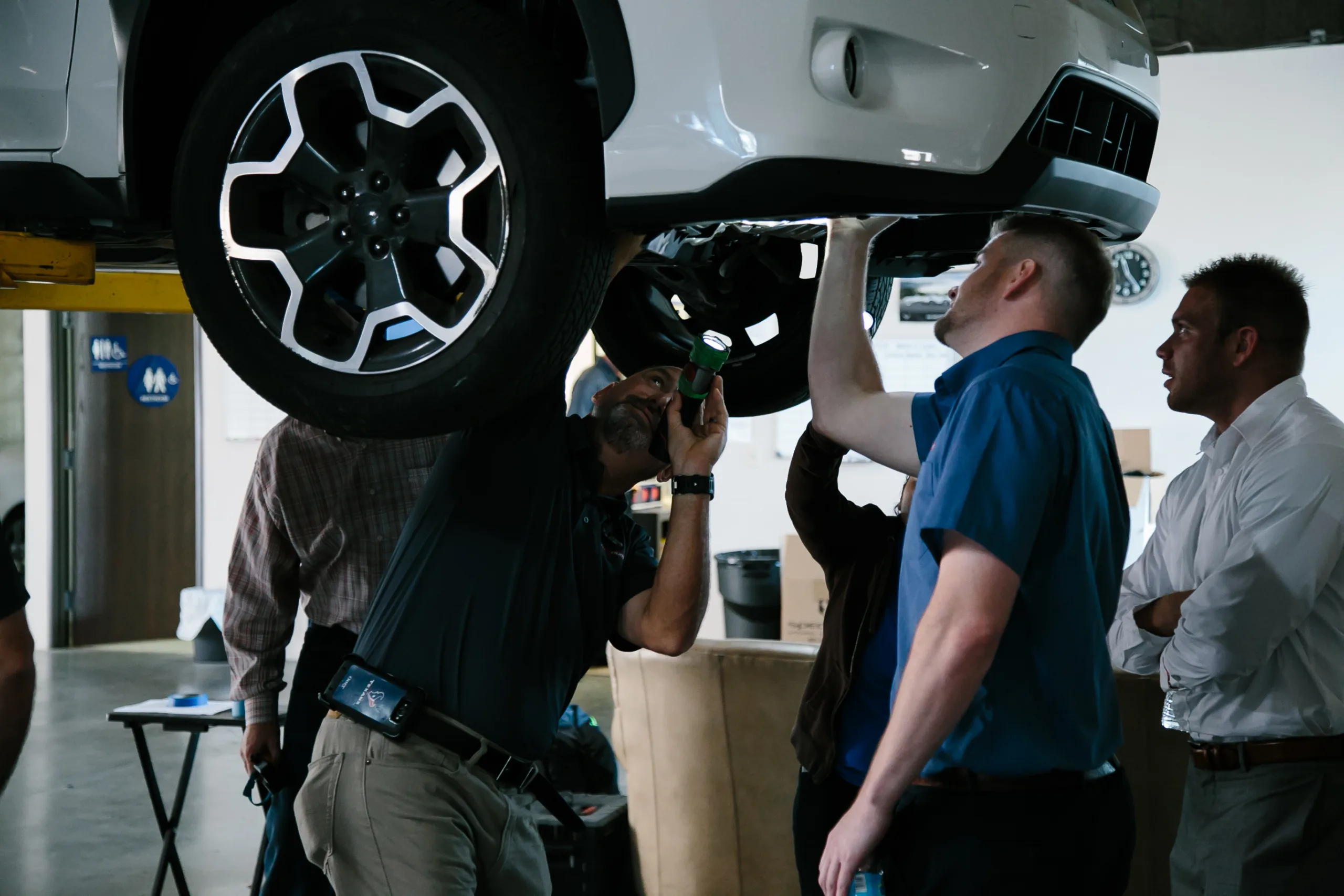 Rebuilders & Inspectors reviewing a vehicle.