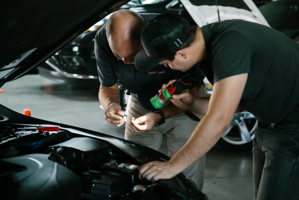 Two Rebuilders inspecting work on a vehicle